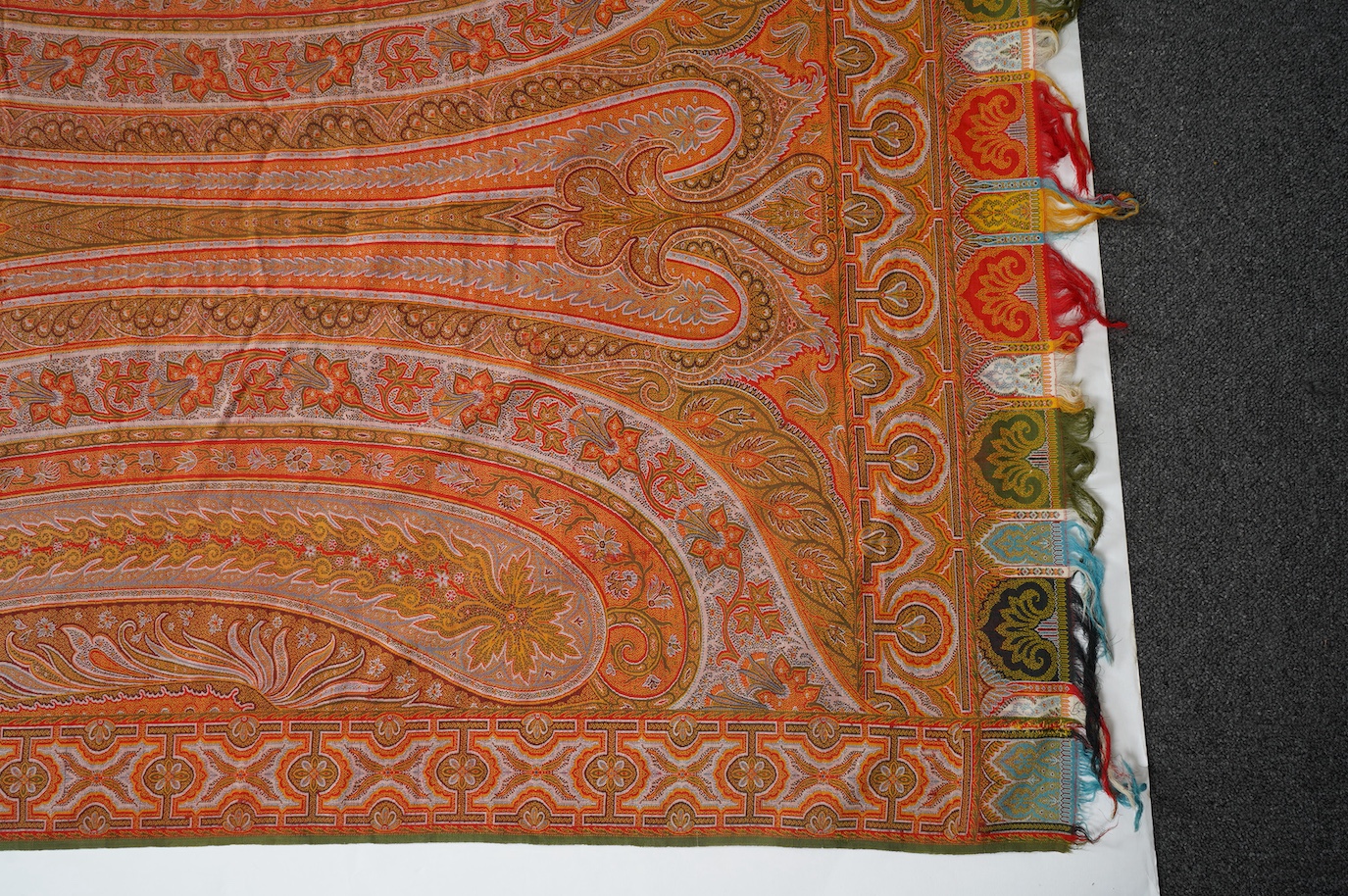 A French possibly Lyon, 19th century ornate silk and fine wool woven Paisley patterned shawl. Woven in polychromes coloured silks and wools on a jacquard loom, using an array of punch cards to create this elaborate desig